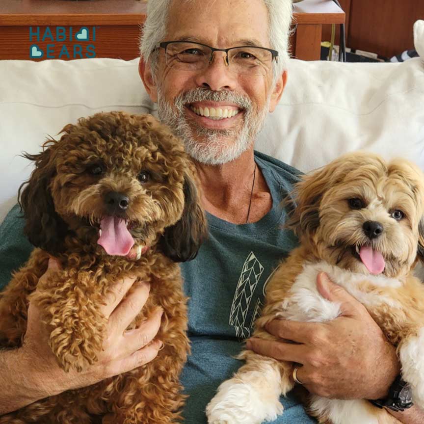 man with Maltipoo puppies
