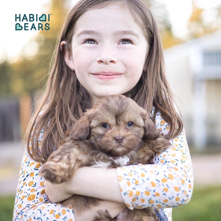 Young girl hugging a puppy